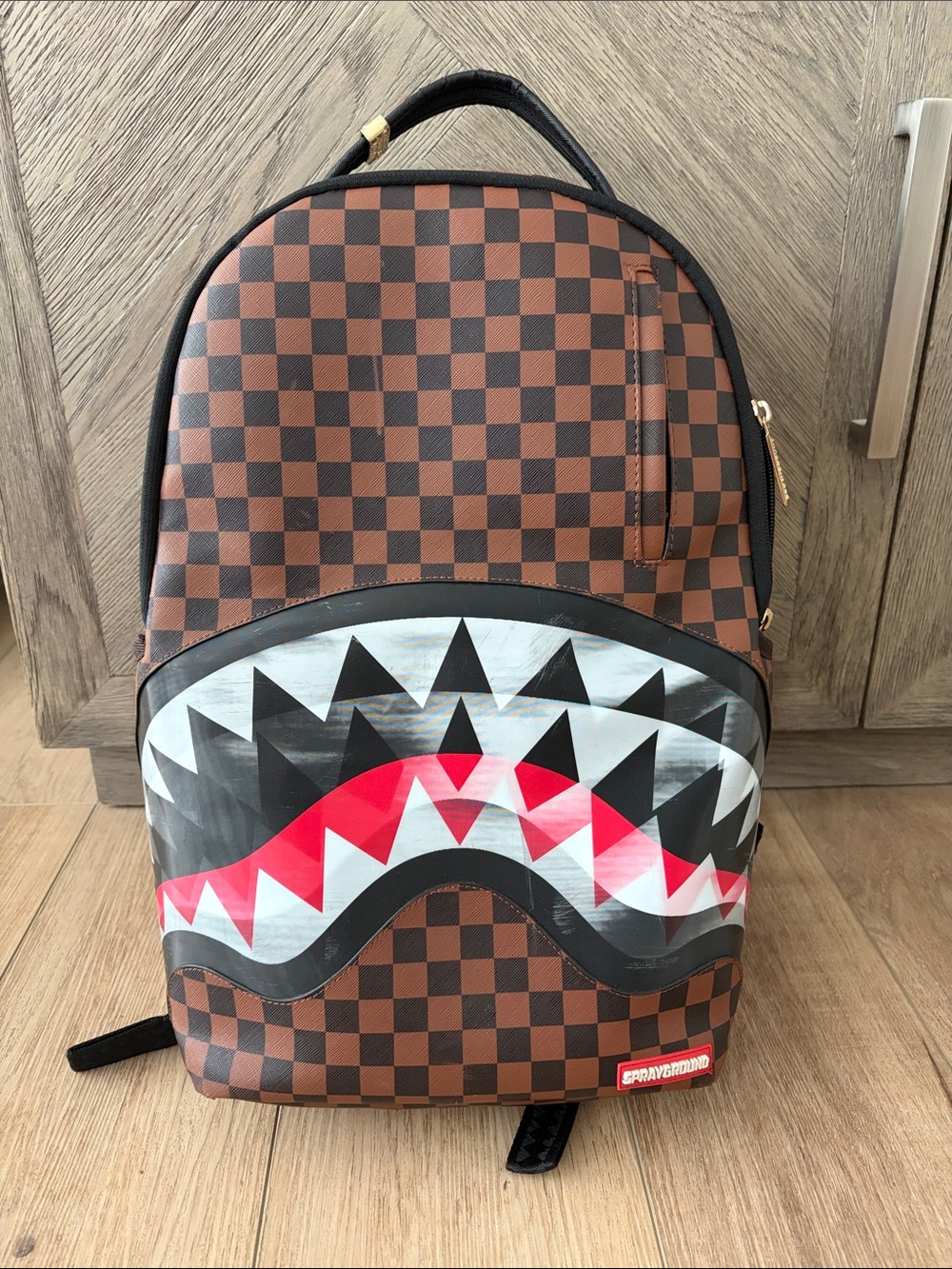 Sprayground Brown Checkerboard Backpack with Red & White Shark Mouth